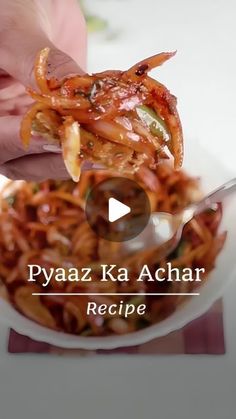 a person is holding up some food in a bowl with the words pyaza ka achar recipe on it