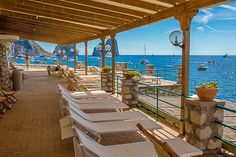 several lounge chairs are lined up on the deck