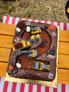 a chocolate cake with construction vehicles on it