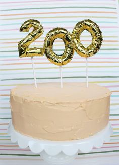 a birthday cake with gold foil numbers on top