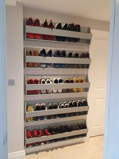 there are many pairs of shoes on the shelves in this room, all lined up