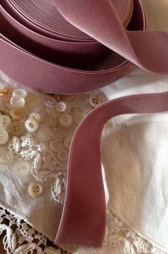 several different types of ribbons and buttons on a table