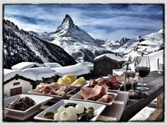 a table topped with plates of food and glasses of wine