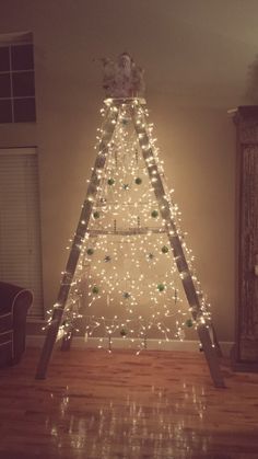 a christmas tree made out of ladders and lights