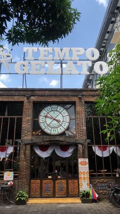 a large clock on the front of a restaurant