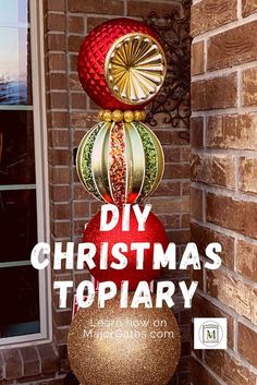 a red and gold christmas ornament sitting on top of a brick building with the words diy christmas topiary above it