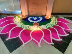 a decorated floor with candles on it in front of a door