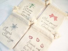 four bags with different designs on them sitting on a white table cloth covered in twine