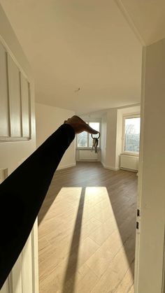 a person's hand reaching for something in an empty room