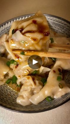 a bowl filled with dumplings and chopsticks