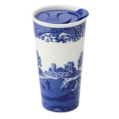 a blue and white porcelain cup with an animal scene on the side, holding a lid