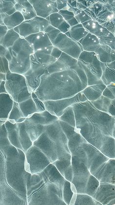 the water is crystal clear and has little ripples on it's surface,