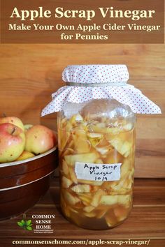 an apple cider vinegar recipe in a jar next to apples on a wooden table