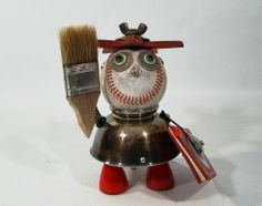 an old fashioned baseball nutcracker with a paintbrush