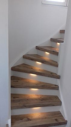 the stairs are made from wood and have lights on them