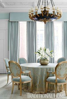 a dining room table with chairs and a chandelier