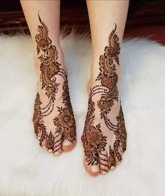 the feet are decorated with henna designs