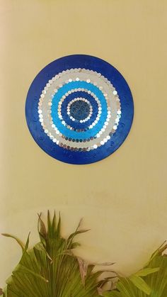 a blue and white plate sitting on top of a table next to some green plants