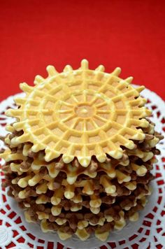 a close up of a cake on a doily with the words pizzale written above it