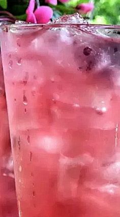 two glasses filled with pink liquid sitting next to each other