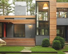 a modern house with wood and glass on the front