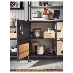 an open cabinet with pots, pans and other cooking utensils on it