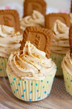 some cupcakes with frosting and cookies on top