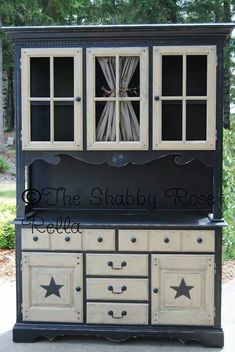 an old china cabinet is painted black and white