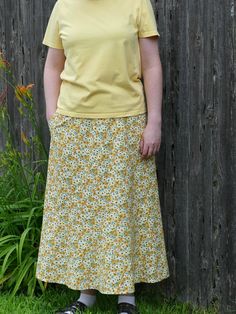 Here is a pretty yellow floral a-line skirt for women. This long skirt is made with a 100% cotton fabric. The fabric has a yellow background with gold and yellow flowers and green leaves all over it. This a-line skirt has a very pretty spiral design giving a snugger fit at the waist and hips, but with plenty of room at the hem. It also has a good sized pocket! This skirt is perfect for church, special occasions, or even just as an everyday skirt. This skirt has a 27" elastic waist that stretches to about 39" and has a length of 34" from the waist to the hem. Thank you for visiting Joyfully Sewn Designs! If you need a bigger or smaller size, please contact me, and I'd be happy to create a custom order just for you! This skirt was made using the delightful "Spiral Boho" skirt pattern by "Sew Cotton Long Skirt With Floral Print, Cotton Floral Print Full Skirt, Fitted Flared Yellow Maxi Skirt, Fitted Yellow Tiered Maxi Skirt, Fitted Yellow Gathered Skirt, Yellow Summer Maxi Skirt With Elastic Waistband, Fitted Yellow Lined Maxi Skirt, Yellow Floral Print Cotton Bottoms, Cotton Floral Print Relaxed Skirt