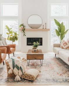 a living room with two couches, a coffee table and a mirror on the wall