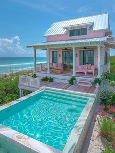 a house with a pool in front of it and the ocean in the back ground