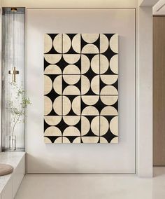 a black and white art piece hanging on the wall in a modern style living room