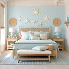 a bedroom decorated in blue and white with starfish on the wall