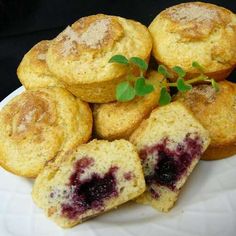 some muffins on a white plate with blueberries