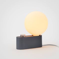 a light that is sitting on top of a black box with a cord attached to it