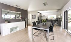 a dining room table and chairs in front of a sliding glass door