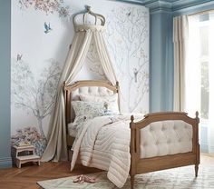 a bedroom with blue walls and white bedding in the corner, along with a canopy bed