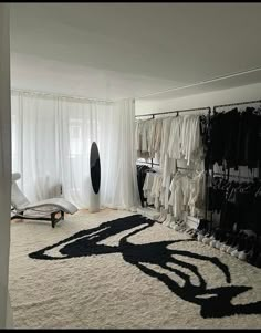 an image of a bedroom setting with clothes on hangers