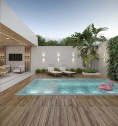 an indoor swimming pool with lounge chairs and palm trees in the backround area