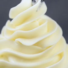 a cupcake with white frosting and a silver fork sticking out of the top