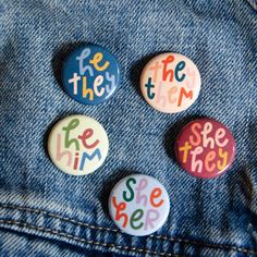 four buttons with the words see, hear, and be there written on them in multi - colored letters