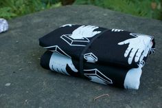 two black and white cloths with hands on them