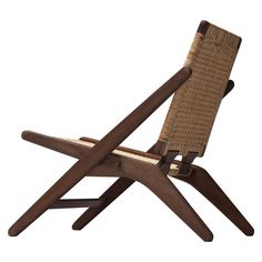 a wooden and wicker lounge chair on a white background