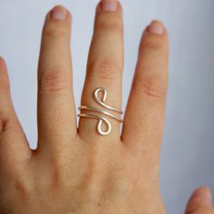 a woman's hand with a silver ring on it