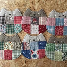 four cat shaped pot holders made out of patchwork