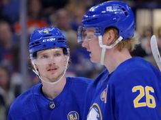 two hockey players standing next to each other