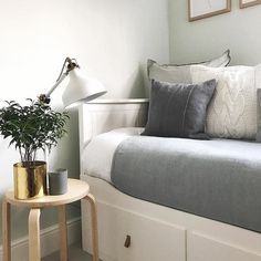 an instagram page with a bed and plant on the end table in front of it