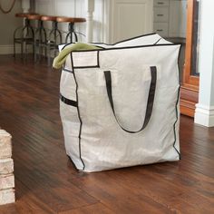 a large white bag sitting on top of a hard wood floor