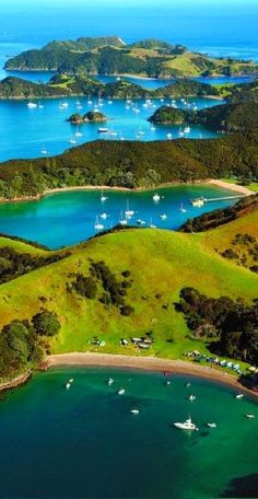 an aerial view of many boats in the water and land around them, including mountains