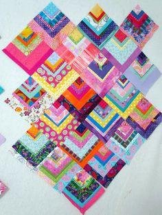 a colorful patchwork quilt is displayed on a table